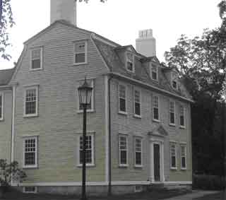 This side-gabled house has a gambrel roof with three dormers.