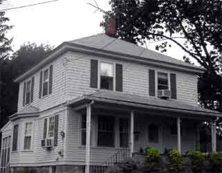 This house, perfectly square-shaped and known as a Four Square, has a hipped roof.