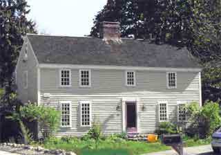 This side-gabled house has single central chimney.