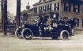 Circa 1918 Fire truck zips past the Swift house on Main St.